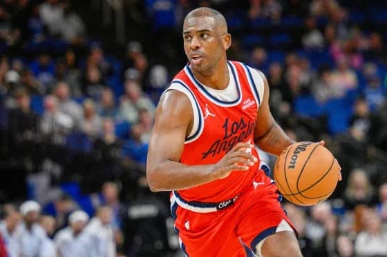 Chris Paul intensely focused, dribbling during an NBA game.