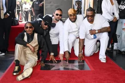 Bone Thugs-N-Harmony pose together beside their Hollywood Walk of Fame star in Los Angeles.