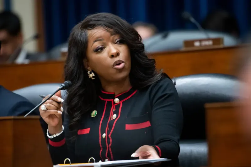 Rep. Jasmine Crockett speaks at a congressional hearing, gesturing emphatically while addressing the room.
