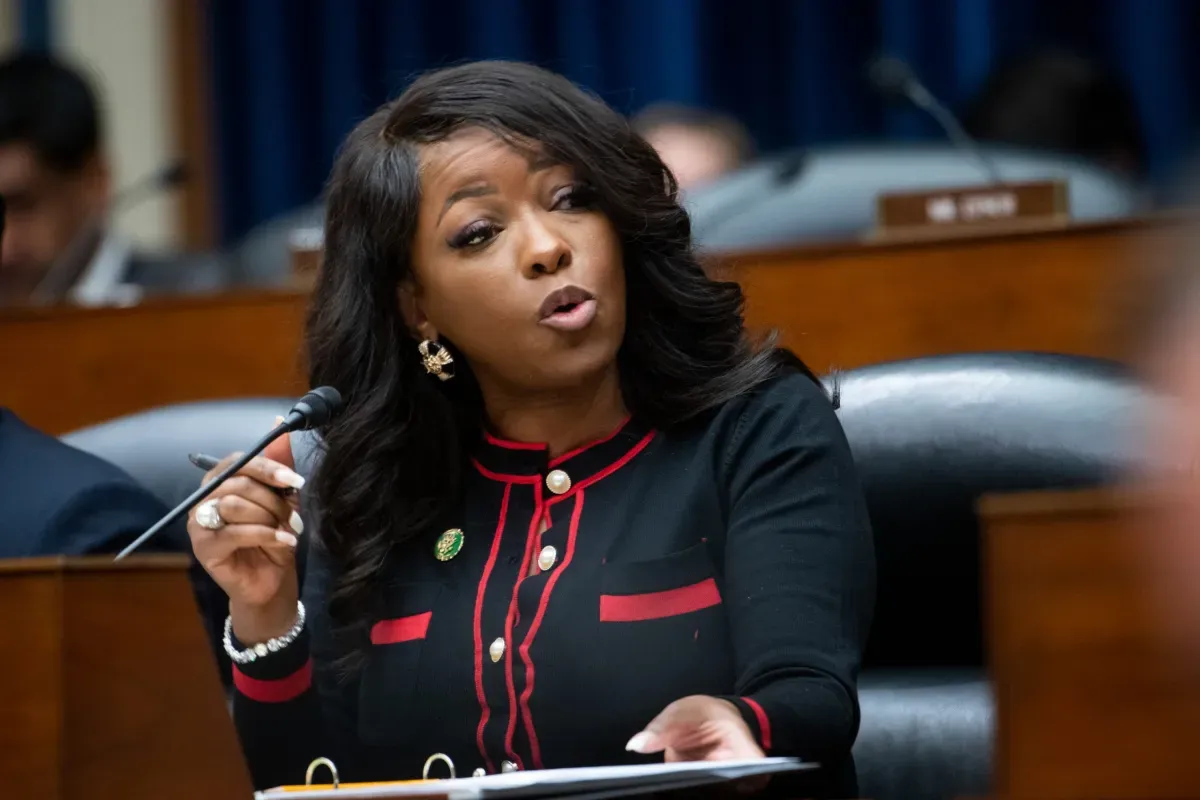 Rep. Jasmine Crockett speaks at a congressional hearing, gesturing emphatically while addressing the room.