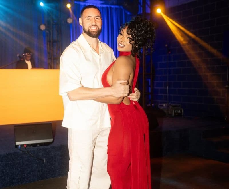 Megan Thee Stallion and Klay Thompson dancing together at his birthday party as guests celebrate around them.