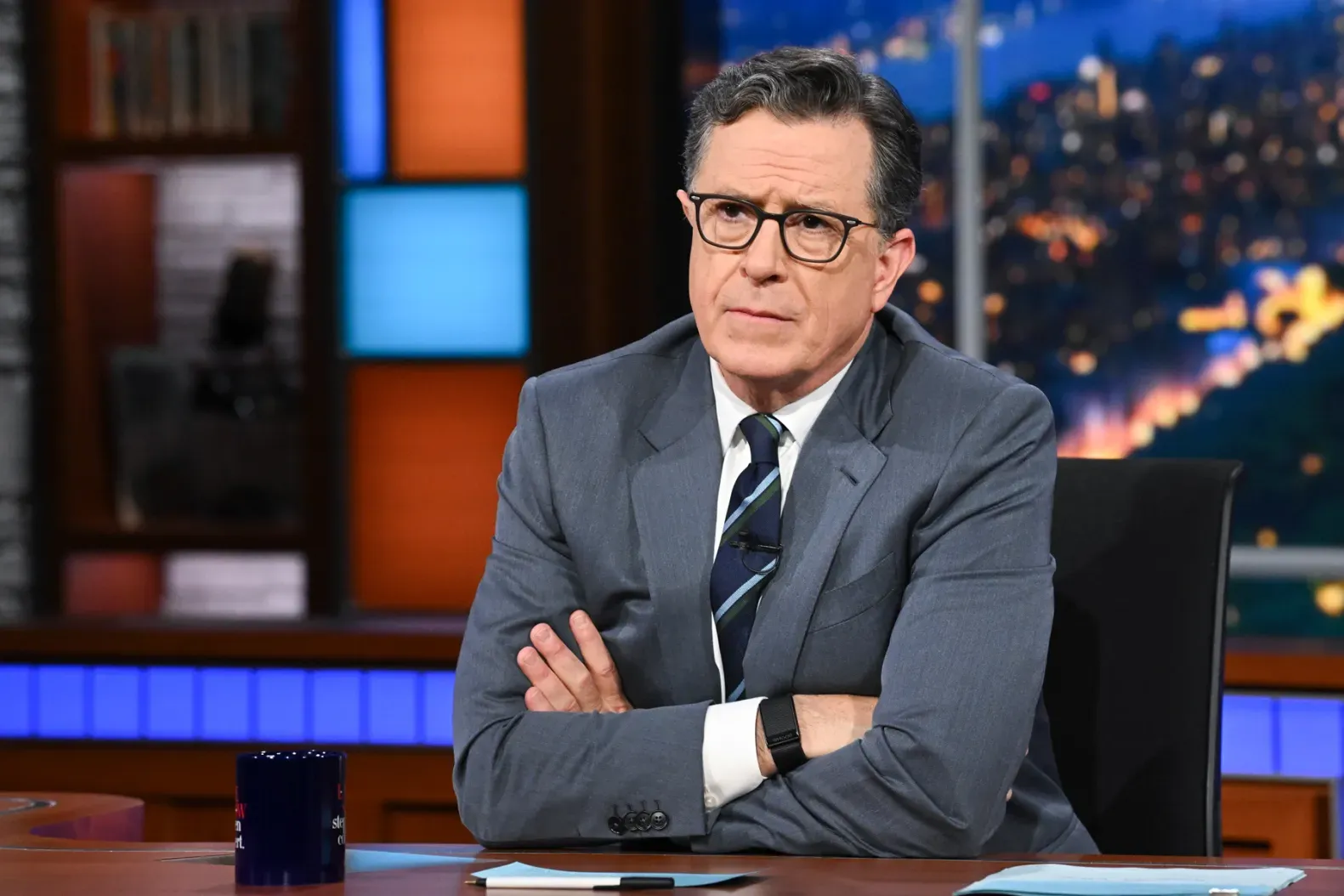 Stephen Colbert passionately speaking during his late-night show, displaying fierce energy.