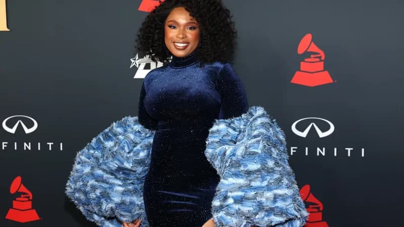 Jennifer Hudson performing as Effie White in “Dreamgirls,” standing center stage under bright theatrical lighting.